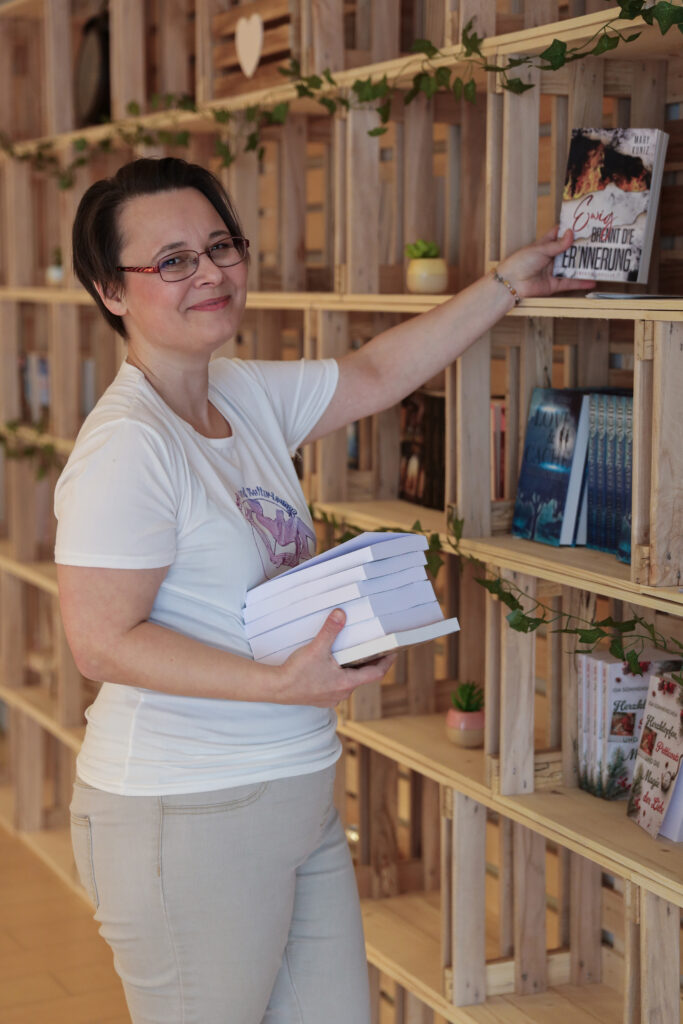 Loungeinhaberin Sissi Steuerwald räumt Bücher von Selfpublishern in ihre Loungekisten.